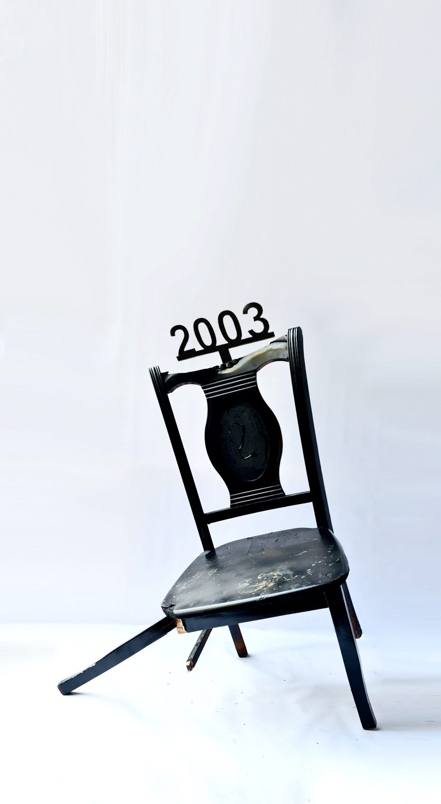 1 of 16, 2003. A regime falls, a chair breaking under its own weight.