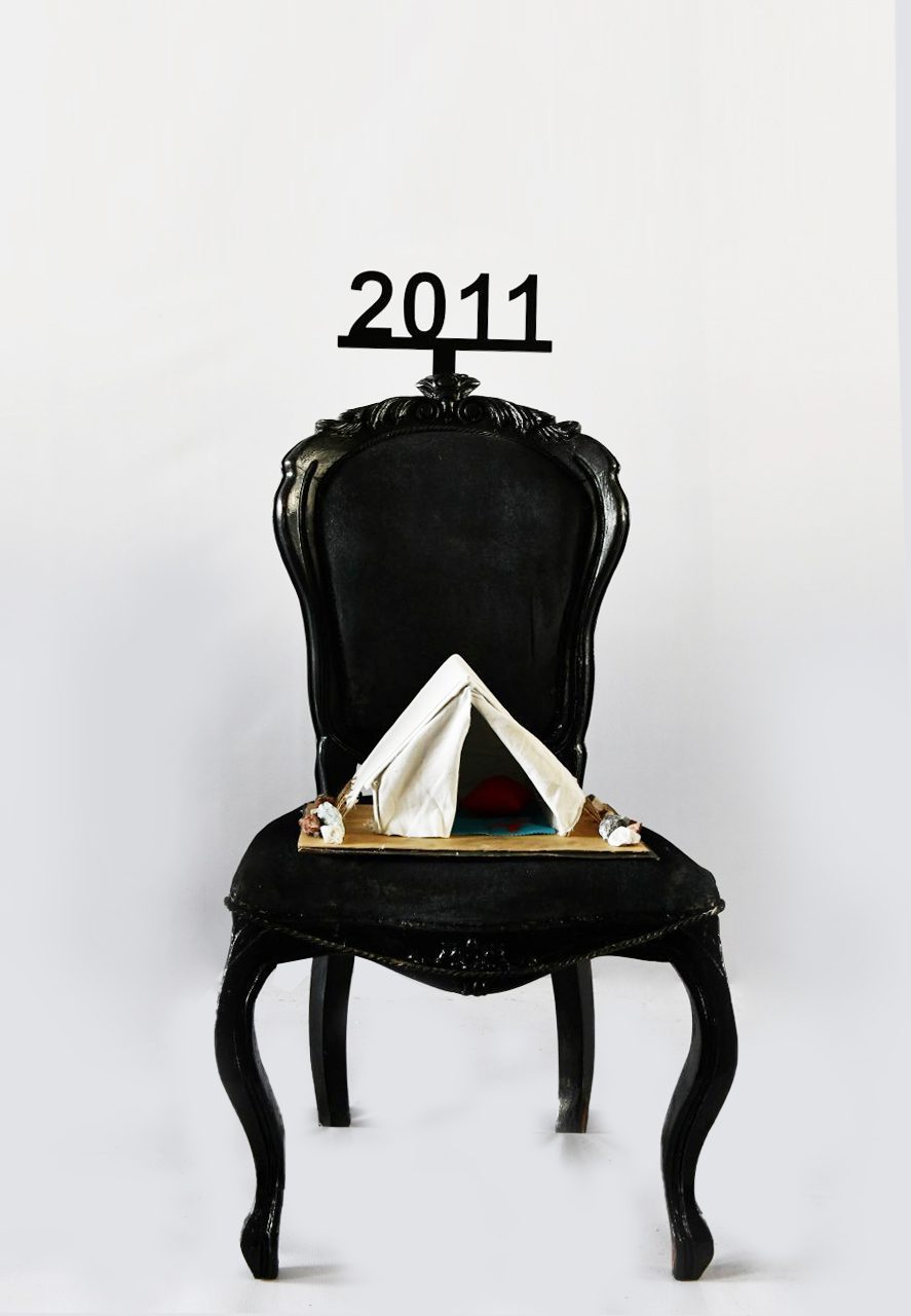 1 of 16, 2011. A refugee tent replaces a seat at the table.