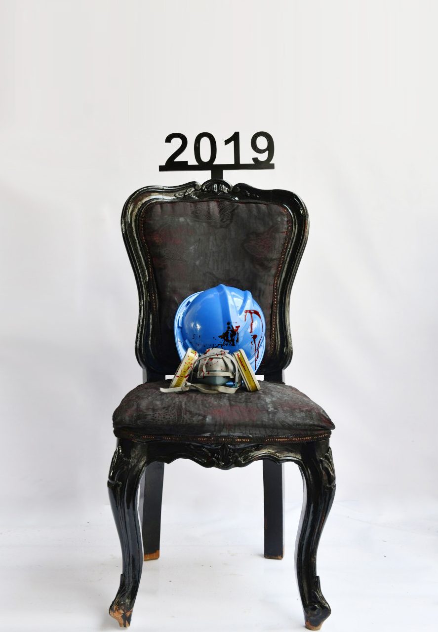 1 of 16, 2019. Hard hats, stained red. The cost of asking for reform.