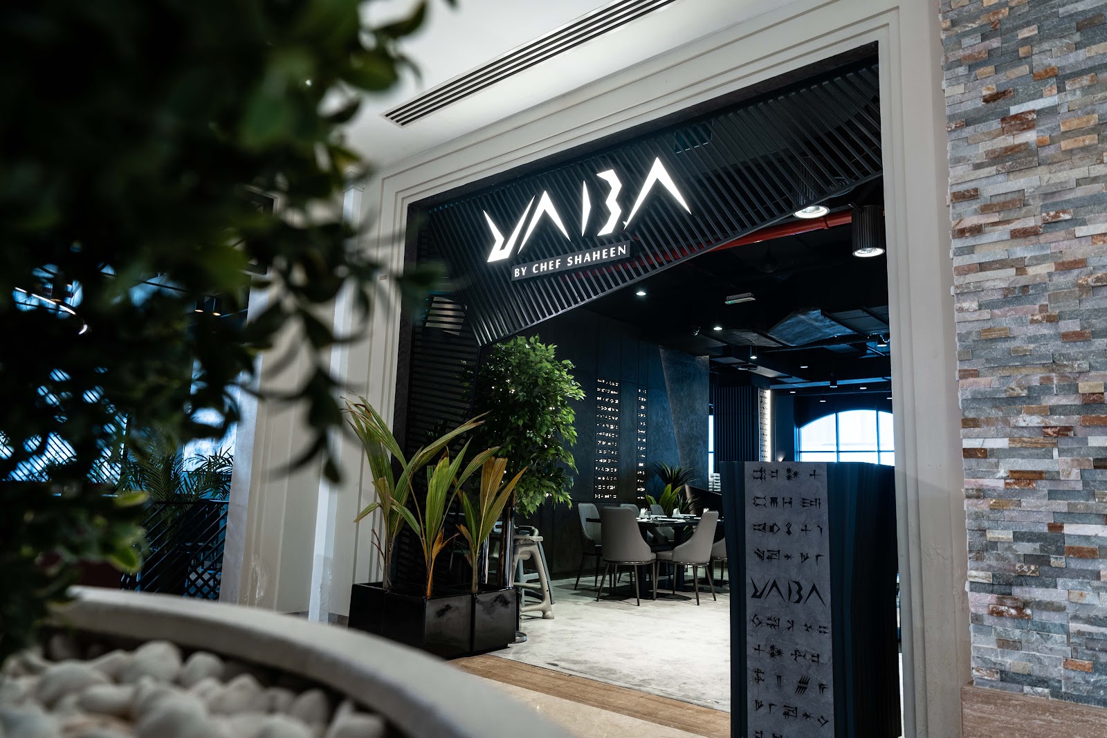 The YABA storefront at Vita Mall, the wordmark lit above a cuneiform-patterned interior